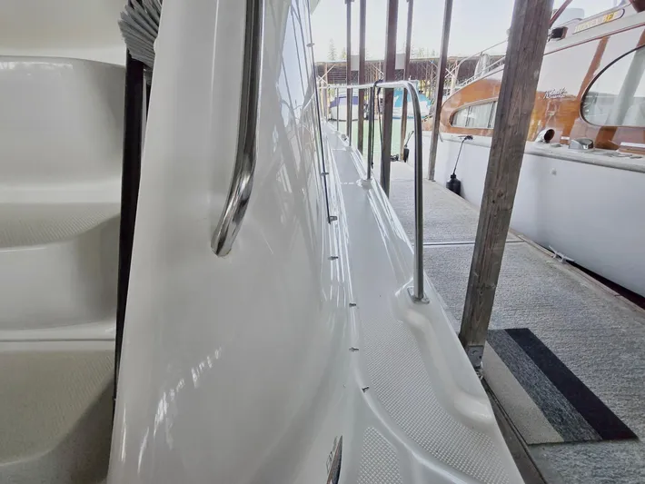 Mad Mary Yacht Photos Pics 2004 Meridian 381 Sedan yacht docked, showing side deck and railing.