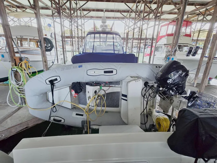 Mad Mary Yacht Photos Pics 2004 Meridian 381 Sedan docked with inflatable boat and outboard motor in marina.