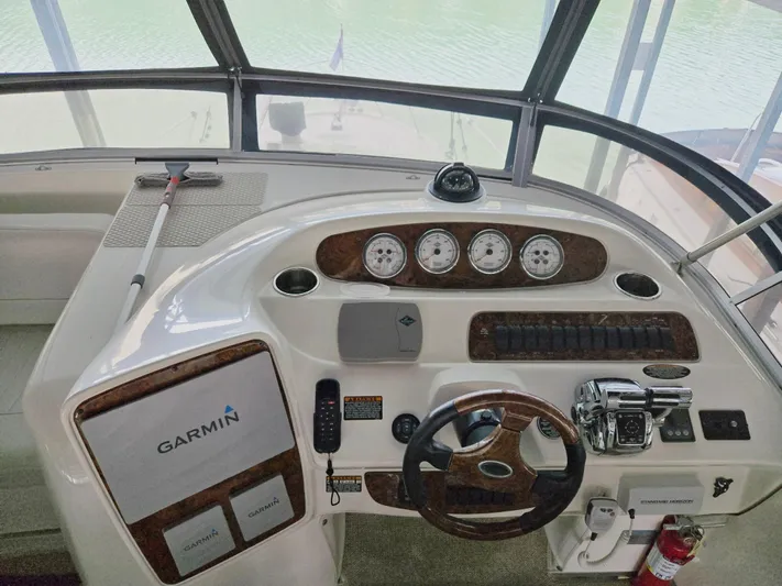 Mad Mary Yacht Photos Pics Helm of 2004 Meridian 381 Sedan with Garmin navigation and classic wood accents.