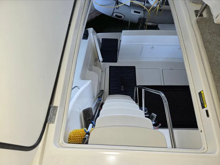 Mad Mary Yacht Photos Pics Staircase view inside 2004 Meridian 381 Sedan yacht, featuring clean white steps and railing.