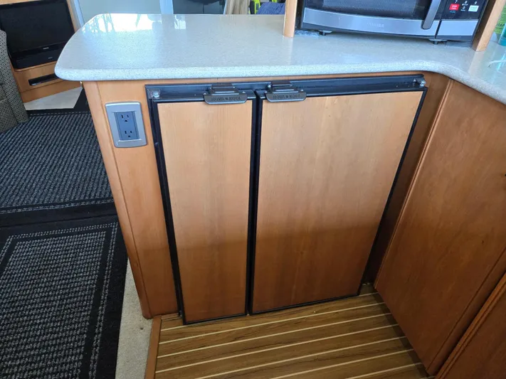 Mad Mary Yacht Photos Pics Wooden cabinet with double doors in a 2004 Meridian 381 Sedan yacht interior.