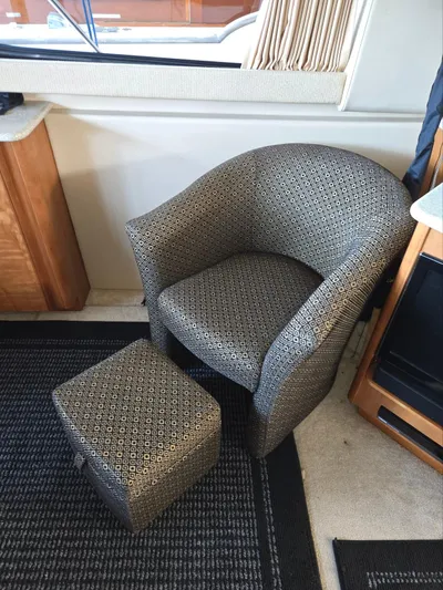 Mad Mary Yacht Photos Pics Comfortable patterned chair and ottoman inside a 2004 Meridian 381 Sedan yacht.