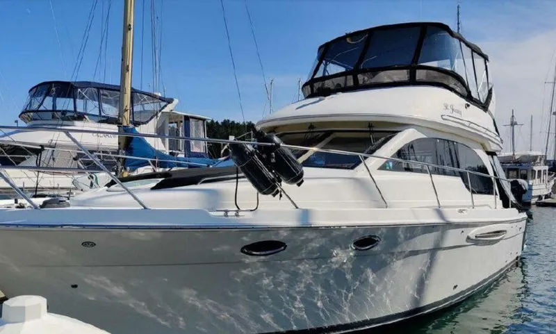 Mad Mary Yacht Photos Pics 2004 Meridian 381 Sedan yacht docked in marina, featuring sleek design and spacious upper deck.