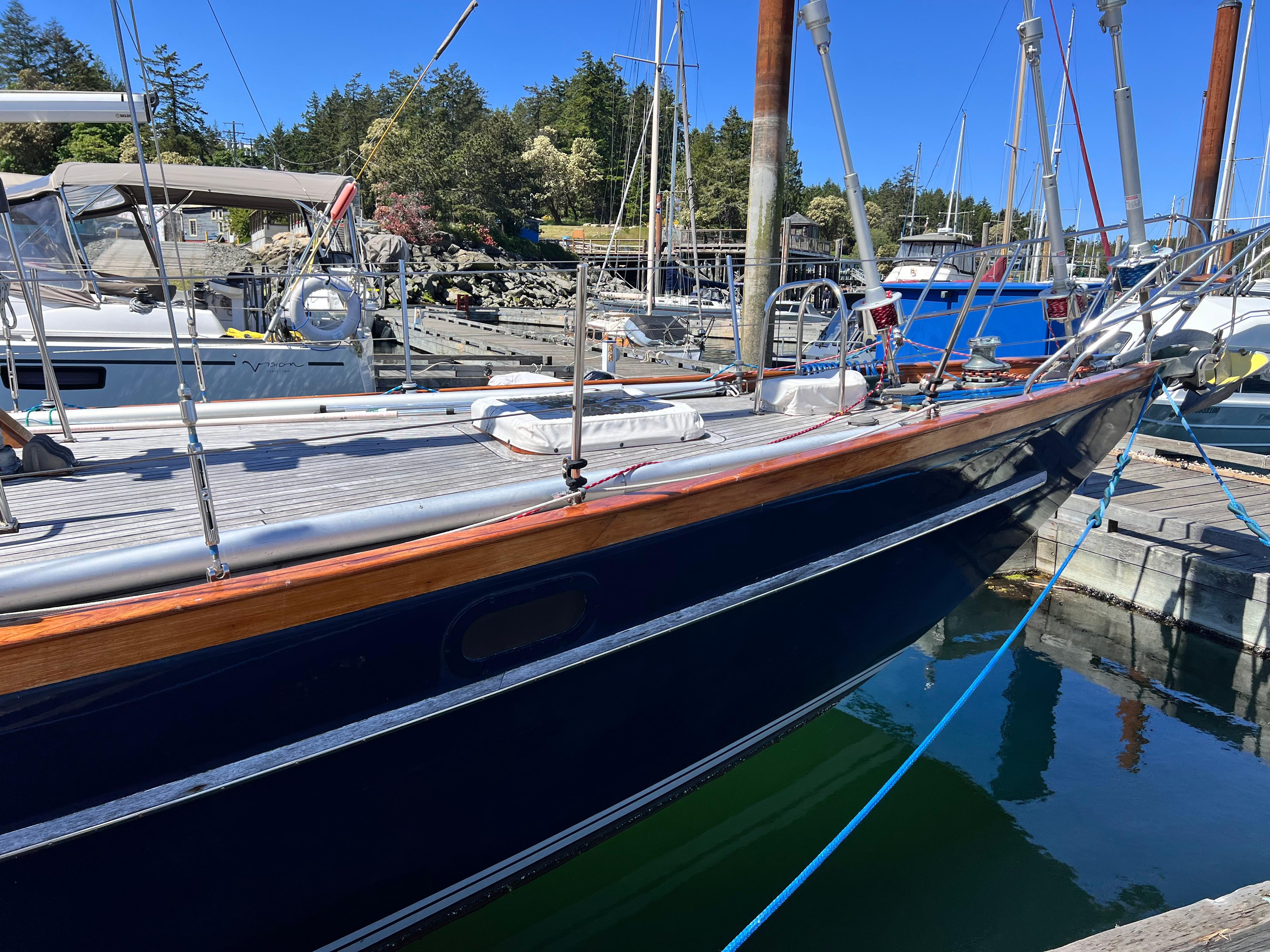 1987 Reliance 45 sailboat docked at marina, featuring sleek design and polished wood accents.