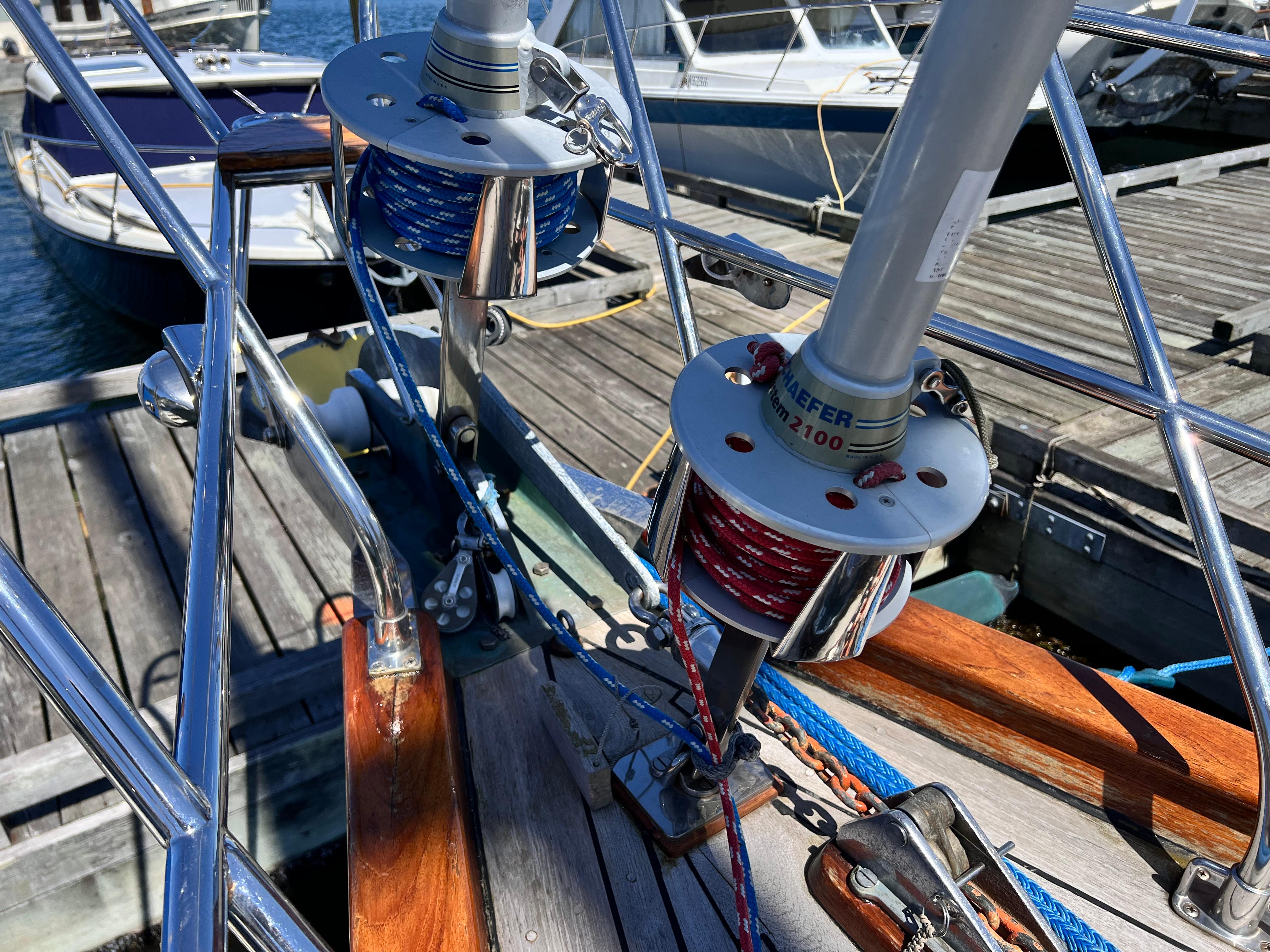 Deck view of a 1987 Reliance 45 sailboat with winches and ropes at a marina.