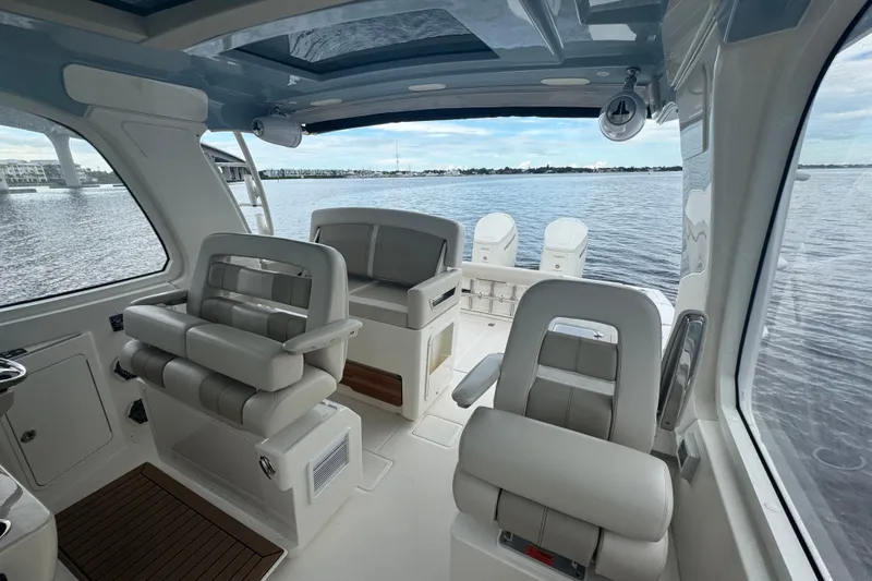  Yacht Photos Pics Interior view of 2018 Boston Whaler 380 Realm boat with luxurious seating and water backdrop.