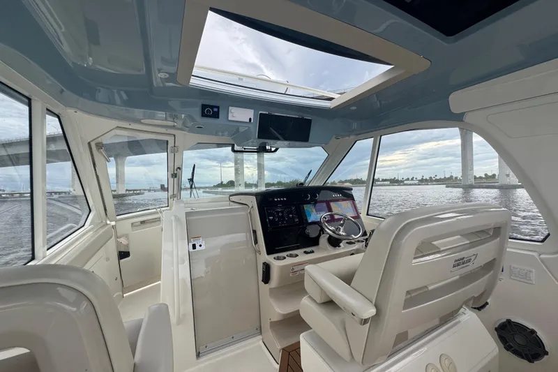  Yacht Photos Pics Interior view of 2018 Boston Whaler 380 Realm boat cockpit with modern navigation system.