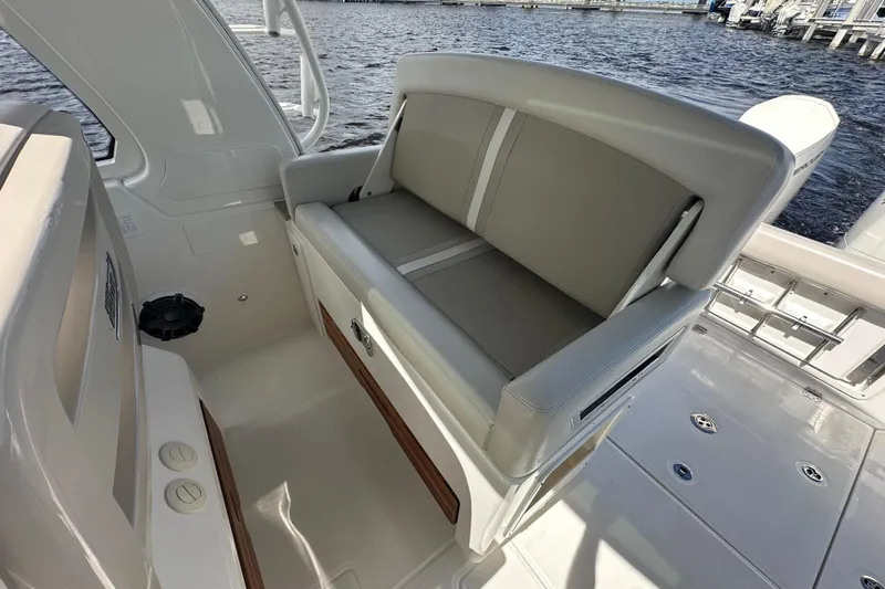  Yacht Photos Pics 2023 Boston Whaler 380 Realm boat interior with cushioned seating and water view.