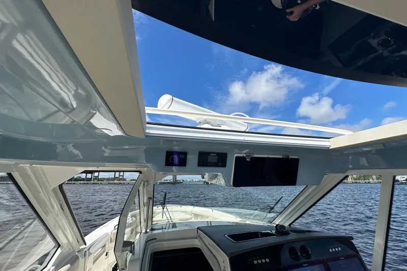  Yacht Photos Pics Interior view of 2023 Boston Whaler 380 Realm boat with clear sky and water backdrop.