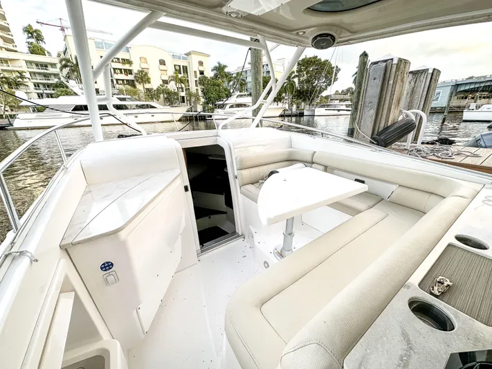  Yacht Photos Pics 2017 Everglades 360 LXC boat interior with seating and table, docked at marina.