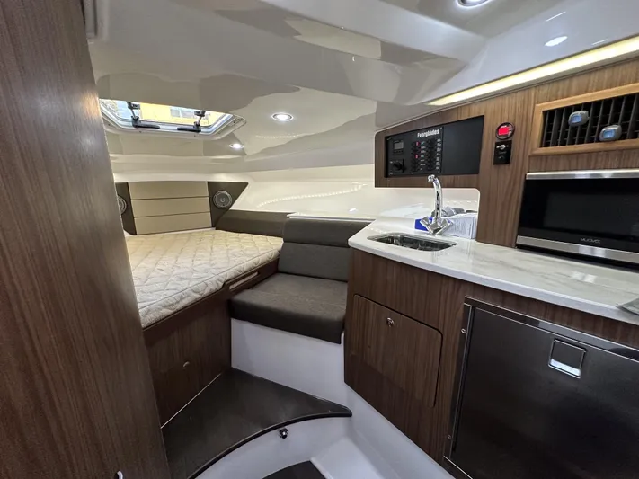  Yacht Photos Pics 2017 Everglades 360 LXC cabin interior with bed, kitchenette, and modern amenities.