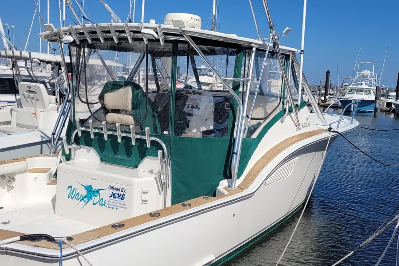 Wave Dancer Yacht Photos Pics 2002 SeaTek 36 Express boat docked at marina, featuring green canopy and fishing rod holders.