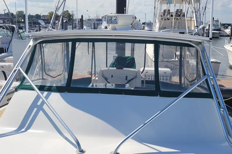 Wave Dancer Yacht Photos Pics 2002 SeaTek 36 Express boat docked at marina, front view with clear windshield.
