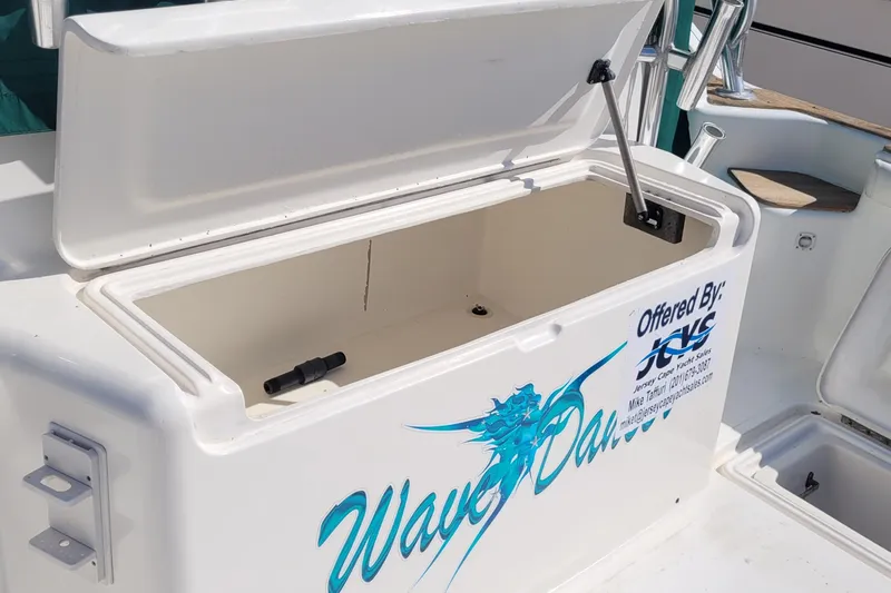 Wave Dancer Yacht Photos Pics Open storage compartment on 2002 SeaTek 36 Express boat, featuring "Wave Dancer" branding.