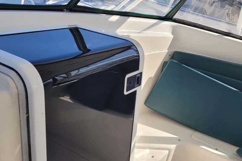 Wave Dancer Yacht Photos Pics Interior of 2002 SeaTek 36 Express boat with teal seating and sleek black panel.