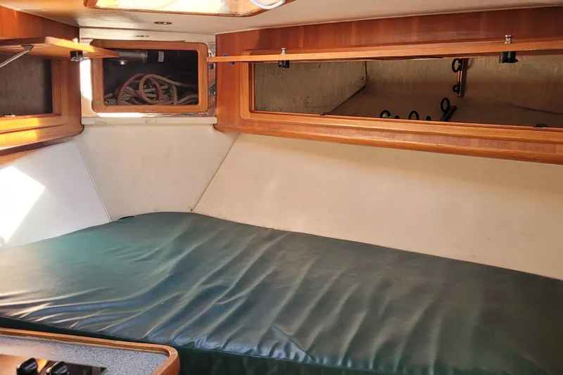 Wave Dancer Yacht Photos Pics Interior cabin of 2002 SeaTek 36 Express boat with wooden storage and green cushion.