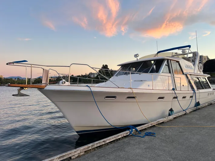  Yacht Photos Pics 1988 Bayliner 4588 yacht docked at sunset with scenic sky and water backdrop.