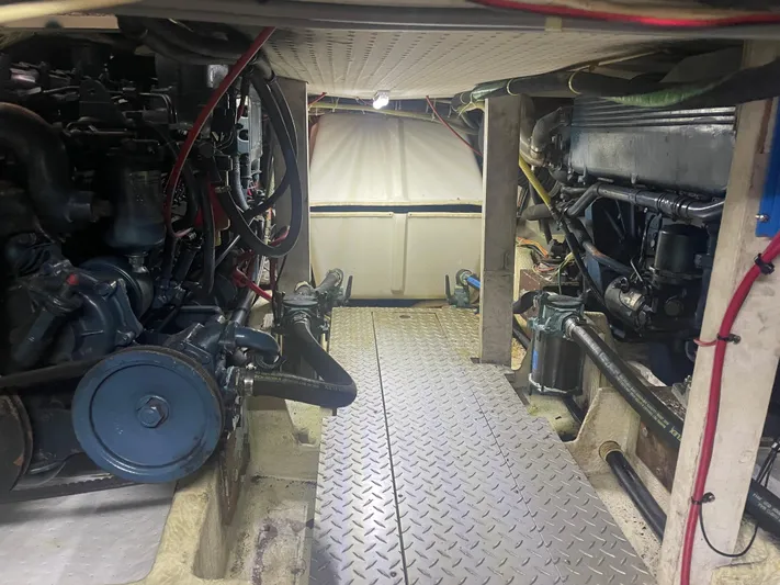  Yacht Photos Pics Engine room of a 1988 Bayliner 4588 yacht, showcasing mechanical components and wiring.