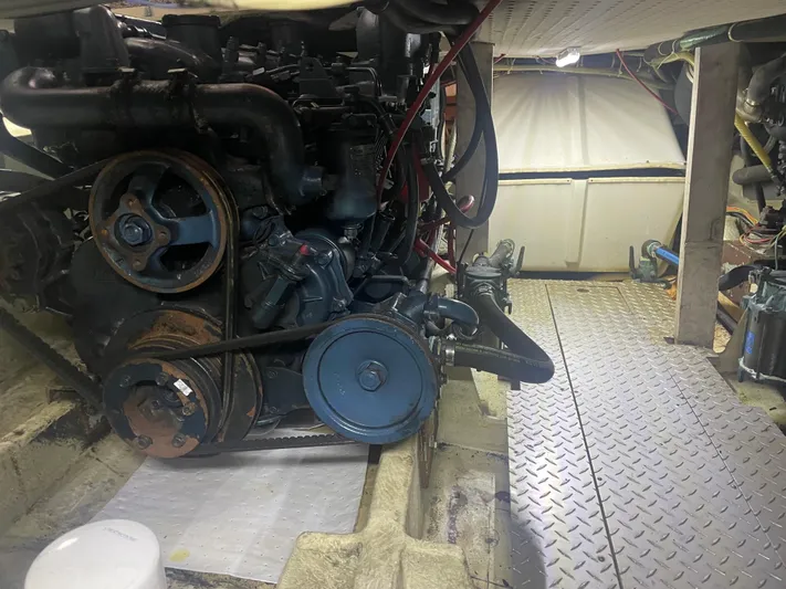  Yacht Photos Pics Engine room of a 1988 Bayliner 4588 yacht, featuring mechanical components and metal flooring.