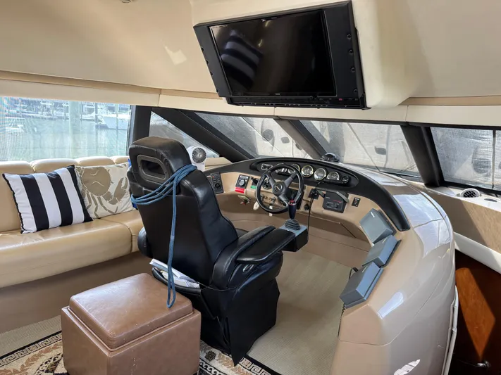 Captain & The Kids Yacht Photos Pics 1998 Carver 530 Voyager helm with leather seat, modern controls, and large windows.