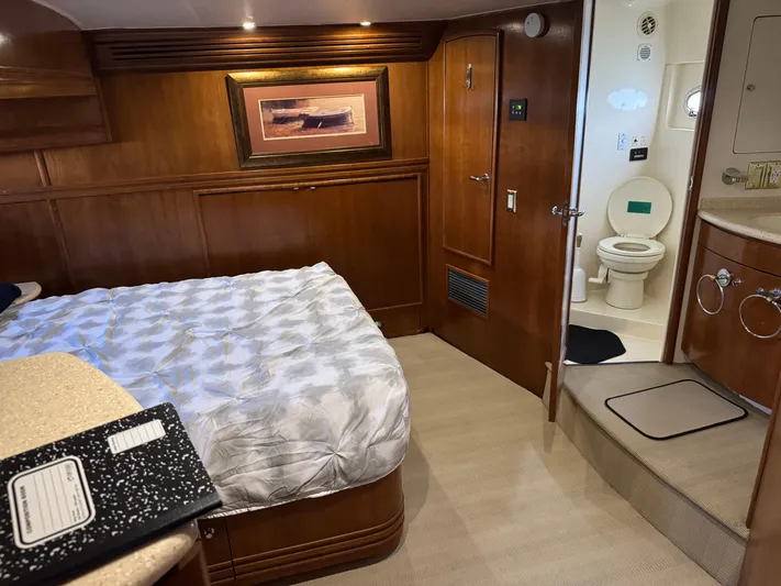 Captain & The Kids Yacht Photos Pics Luxurious 1998 Carver 530 VOYAGER yacht bedroom with ensuite bathroom and elegant wood finishes.