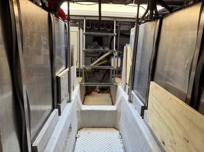 Captain & The Kids Yacht Photos Pics Engine room of 1998 Carver 530 VOYAGER yacht with visible equipment and access ladder.