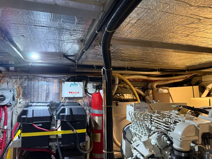 Captain & The Kids Yacht Photos Pics Engine room of a 1998 Carver 530 VOYAGER yacht with equipment and wiring.