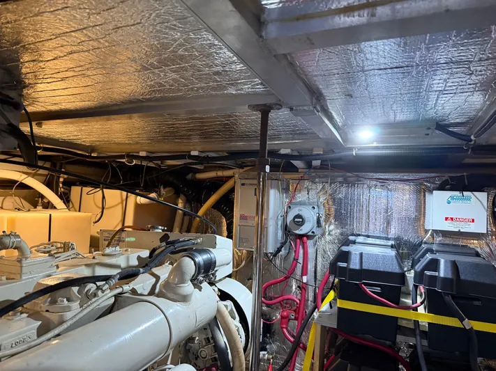 Captain & The Kids Yacht Photos Pics Engine room of a 1998 Carver 530 VOYAGER yacht, featuring machinery and wiring.