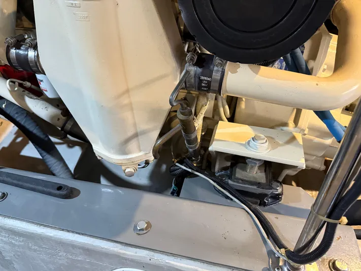 Captain & The Kids Yacht Photos Pics Engine components of a 1998 Carver 530 VOYAGER yacht, showcasing hoses and mechanical parts.