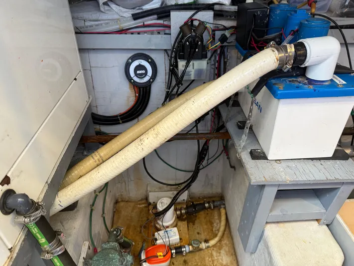 Captain & The Kids Yacht Photos Pics Engine room of a 1998 Carver 530 VOYAGER with visible hoses and equipment.