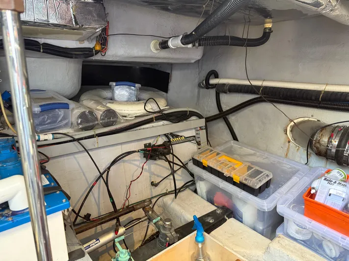 Captain & The Kids Yacht Photos Pics Engine room of a 1998 Carver 530 VOYAGER with storage boxes and wiring.