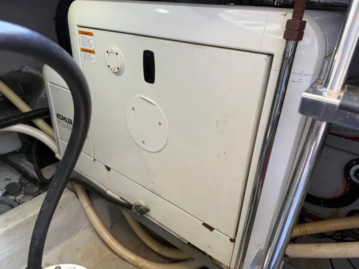 Captain & The Kids Yacht Photos Pics Engine room of 1998 Carver 530 VOYAGER with Kohler power generator.