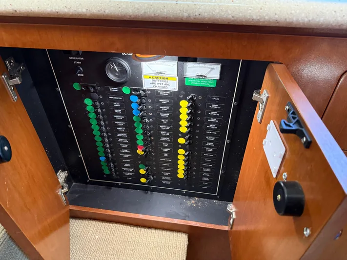 Captain & The Kids Yacht Photos Pics Electrical panel inside a 1998 Carver 530 VOYAGER yacht, featuring labeled switches and gauges.