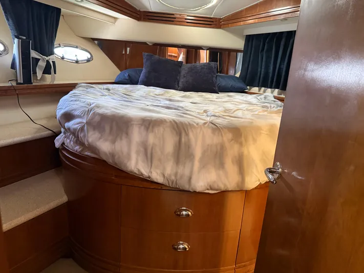 Captain & The Kids Yacht Photos Pics Luxurious bedroom interior of 1998 Carver 530 VOYAGER yacht with plush bedding and wood accents.