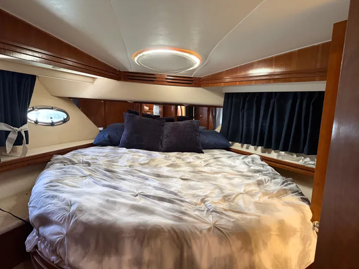 Captain & The Kids Yacht Photos Pics Luxurious bedroom interior of 1998 Carver 530 VOYAGER yacht with cozy bedding.