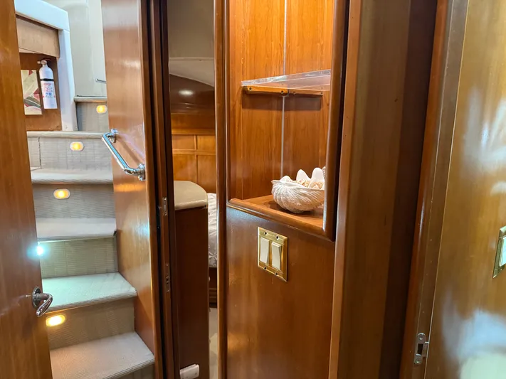 Captain & The Kids Yacht Photos Pics Interior of 1998 Carver 530 Voyager yacht with wooden cabinetry and carpeted stairs.