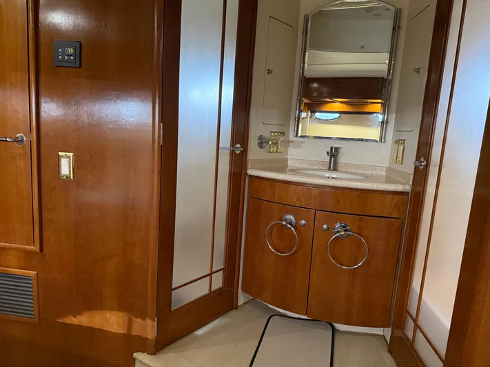 Captain & The Kids Yacht Photos Pics Luxurious bathroom interior of 1998 Carver 530 Voyager yacht with wooden cabinetry.