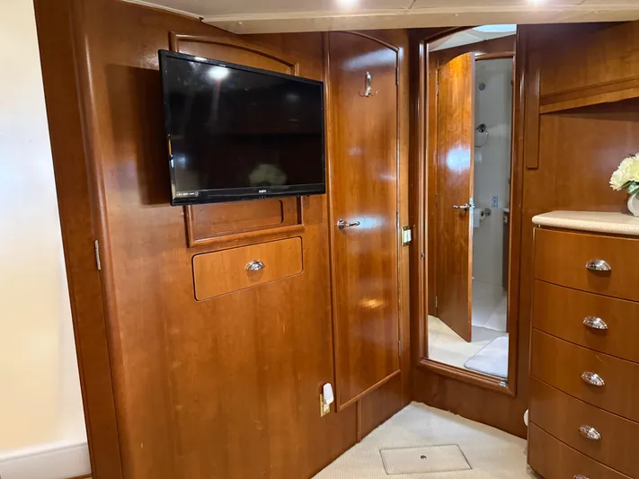 Captain & The Kids Yacht Photos Pics Interior of 1998 Carver 530 Voyager yacht with wood paneling and mounted TV.