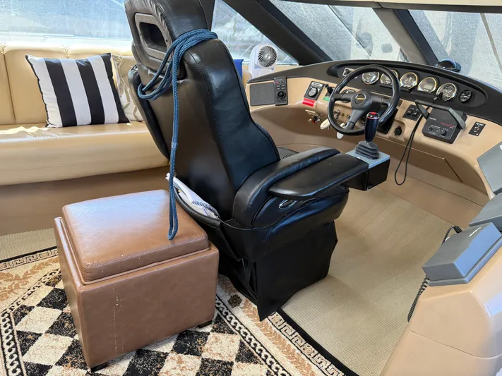 Captain & The Kids Yacht Photos Pics 1998 Carver 530 Voyager helm with leather seat, control panel, and nautical decor.