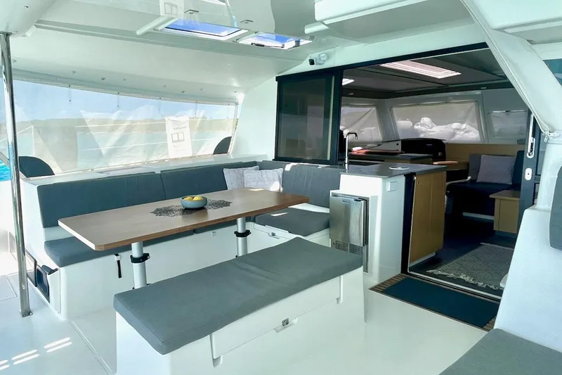 Still Knot A Clue Yacht Photos Pics Interior of 2015 Fountaine Pajot Helia Maestro catamaran with modern seating and dining area.