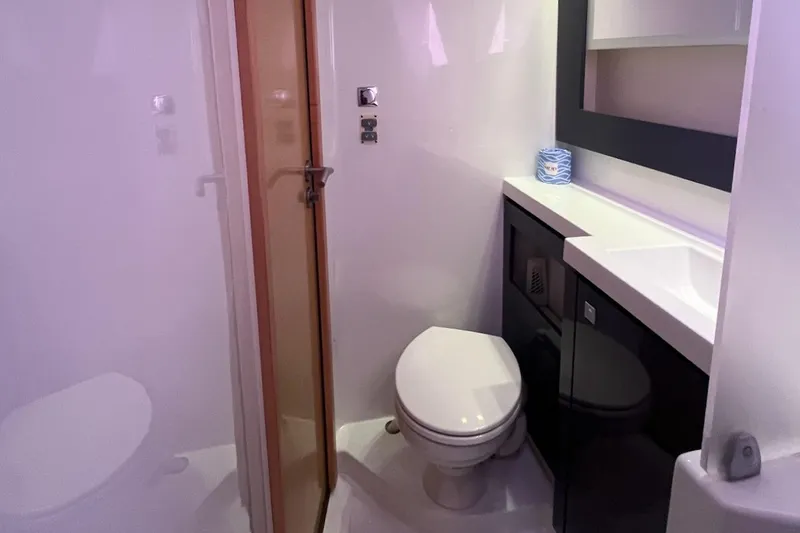 Still Knot A Clue Yacht Photos Pics Bathroom interior of 2015 Fountaine Pajot Helia Maestro catamaran, featuring modern fixtures.