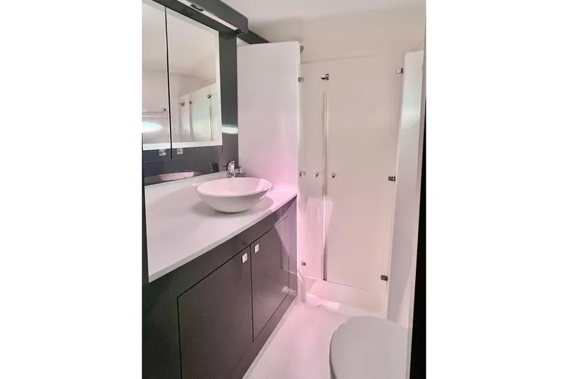Still Knot A Clue Yacht Photos Pics Bathroom interior of 2015 Fountaine Pajot Helia Maestro catamaran, featuring modern sink and cabinetry.