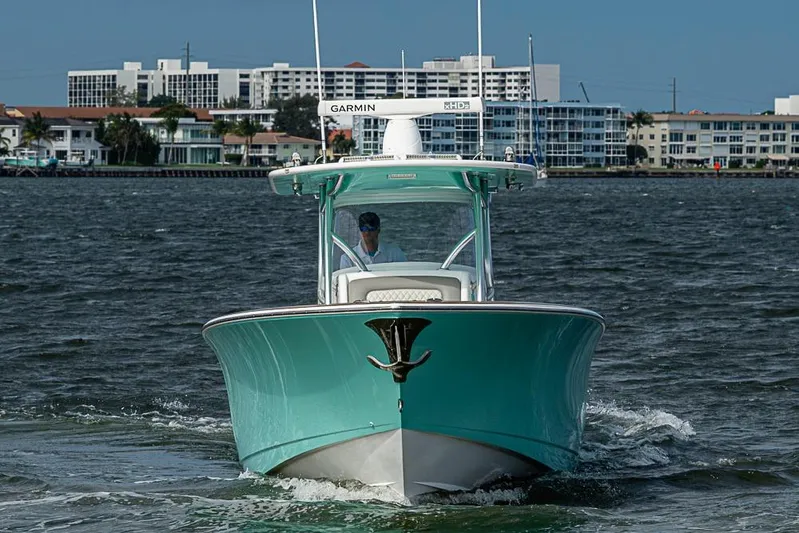 Eos Yacht Photos Pics 2020 Valhalla Boatworks V-37 cruising on water near coastal buildings.