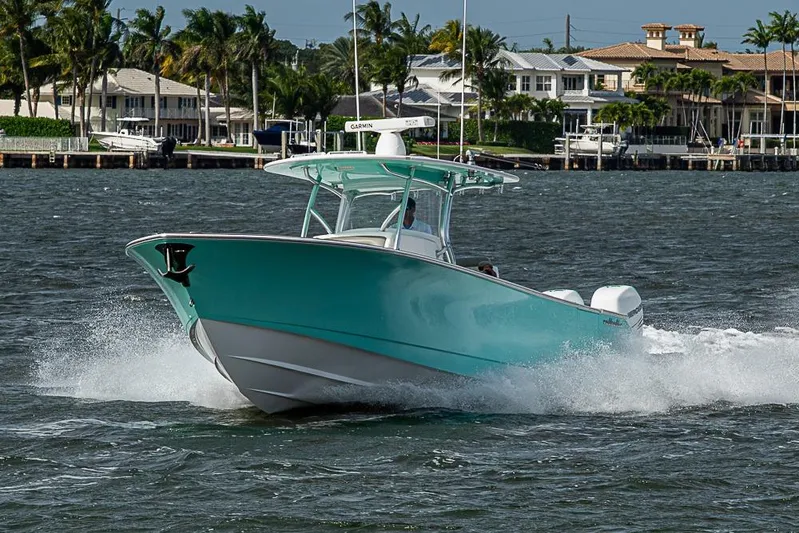 Eos Yacht Photos Pics 2020 Valhalla Boatworks V-37 cruising on water near waterfront homes.