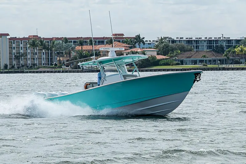 Eos Yacht Photos Pics 2020 Valhalla Boatworks V-37 cruising on water near coastal buildings.