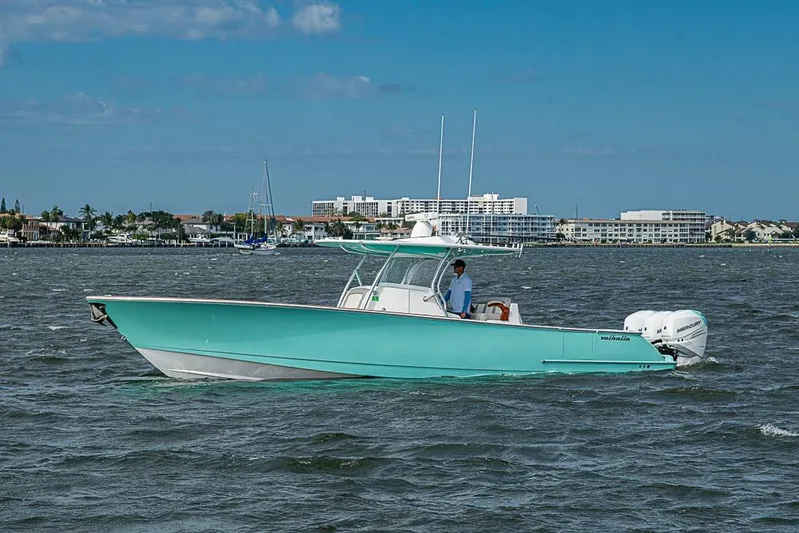 Eos Yacht Photos Pics 2020 Valhalla Boatworks V-37 cruising on a sunny day near coastal buildings.