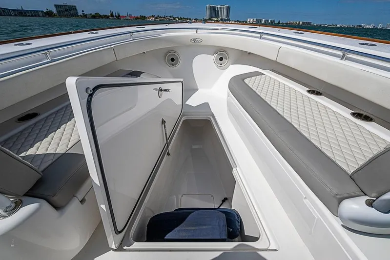 Eos Yacht Photos Pics 2020 Valhalla Boatworks V-37 interior with open storage compartment and cushioned seating.