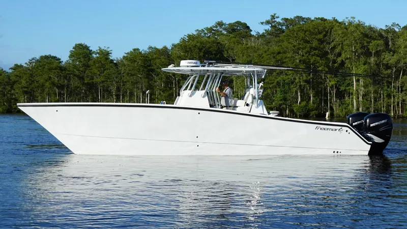  Yacht Photos Pics 2023 Freeman 34VH boat on calm water with forested background.