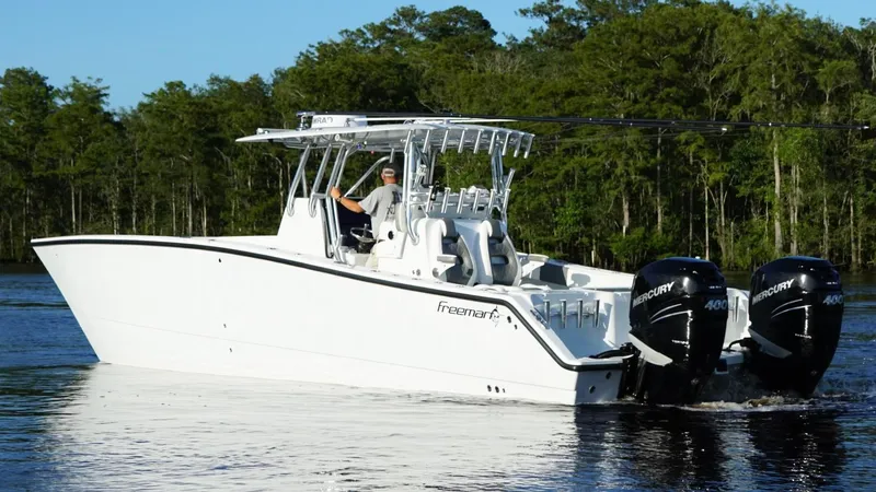  Yacht Photos Pics 2023 Freeman 34VH boat with dual Mercury engines on a serene lake.