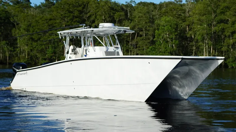  Yacht Photos Pics 2023 Freeman 34VH boat cruising on a calm lake with forested background.
